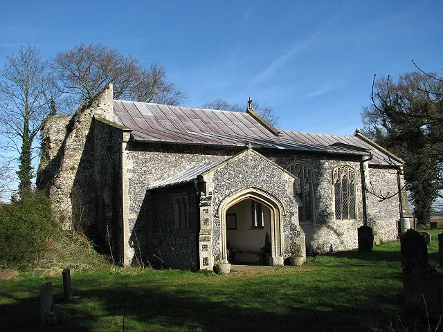 The church of St Nicholas. After the collapse of the church tower in the 18th century, a thatched bell cage > 704031 was erected in the northwestern corner of the churchyard; it houses one bell. The aisle is separated from the chancel by an uninscribed table tomb > 704059, with two squints > 704063 into the chancel at each end. The walls are adorned with a number of interesting corbels > 704080. The church is kept locked but a key is readily available at > 704090. For more information see: http://www.norfolkchurches.co.uk/woodrising/woodrising.htm