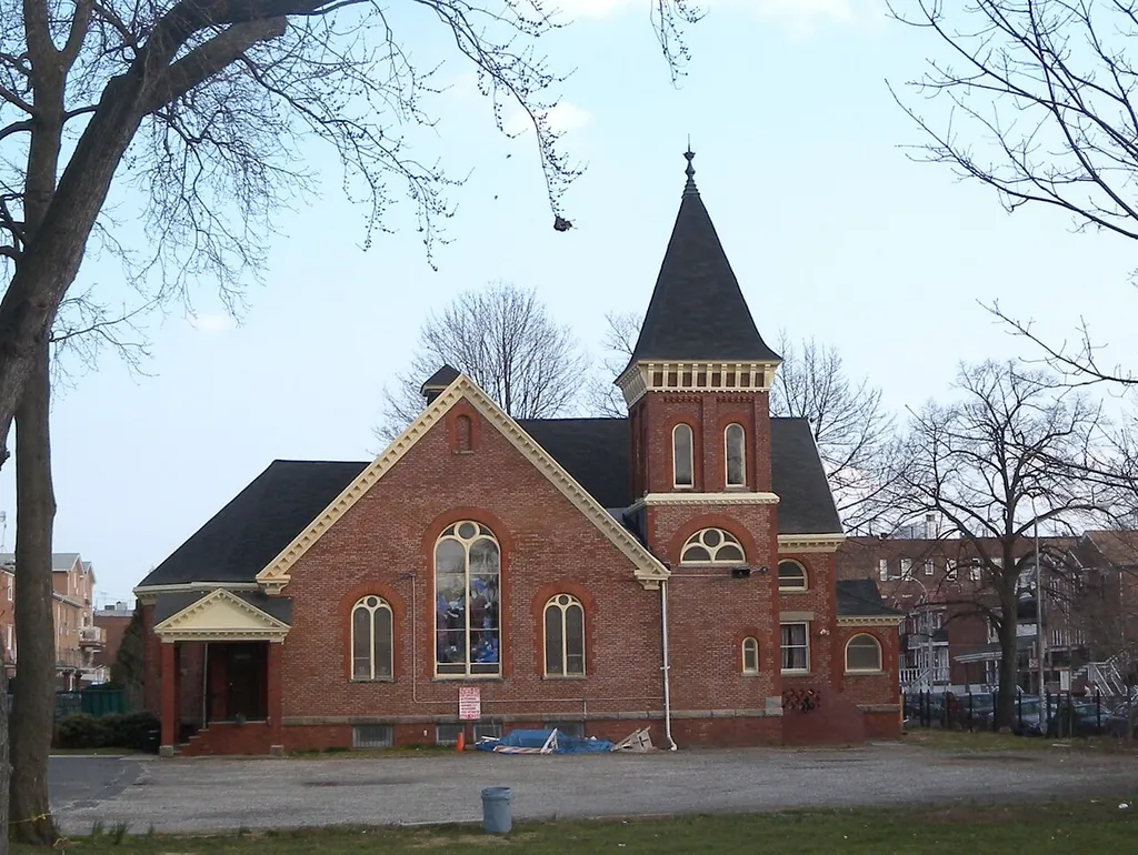 Looking southeast at parish house on a mostly sunny late afternoon.