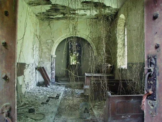 Inside the former parish church of St Peter, Low Toynton, Lincolnshire, looking east to the chancel. The chancel arch is late Norman but the rest of the church was rebuilt in 1811. The church was made redundant in October 1973 and passed into private ownership in 1977.