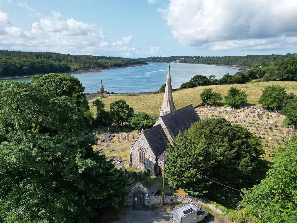 St Mary's Church and surrounding area, Llanfairpwllgwyngyll, Ynys Môn, Cymru Wales. A small Gothic Revival Church. 200 meters, near the shoreline, there is a memorial to Nelson just below Plas Llanfair, in Llanfairpwll. It was created by Admiral Lord Clarence Paget, who lived in the mansion and who was an enthusiastic amateur sculptor. The monument is made of stone, inscribed with the words "Nelson" on the base of the statue. The words "Fell at Trafalgar 1805" are engraved in slate on the west side of the plinth and repeated in welsh on the east side.