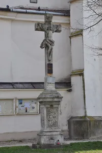 Wayside cross in front of the church in Vojkovice