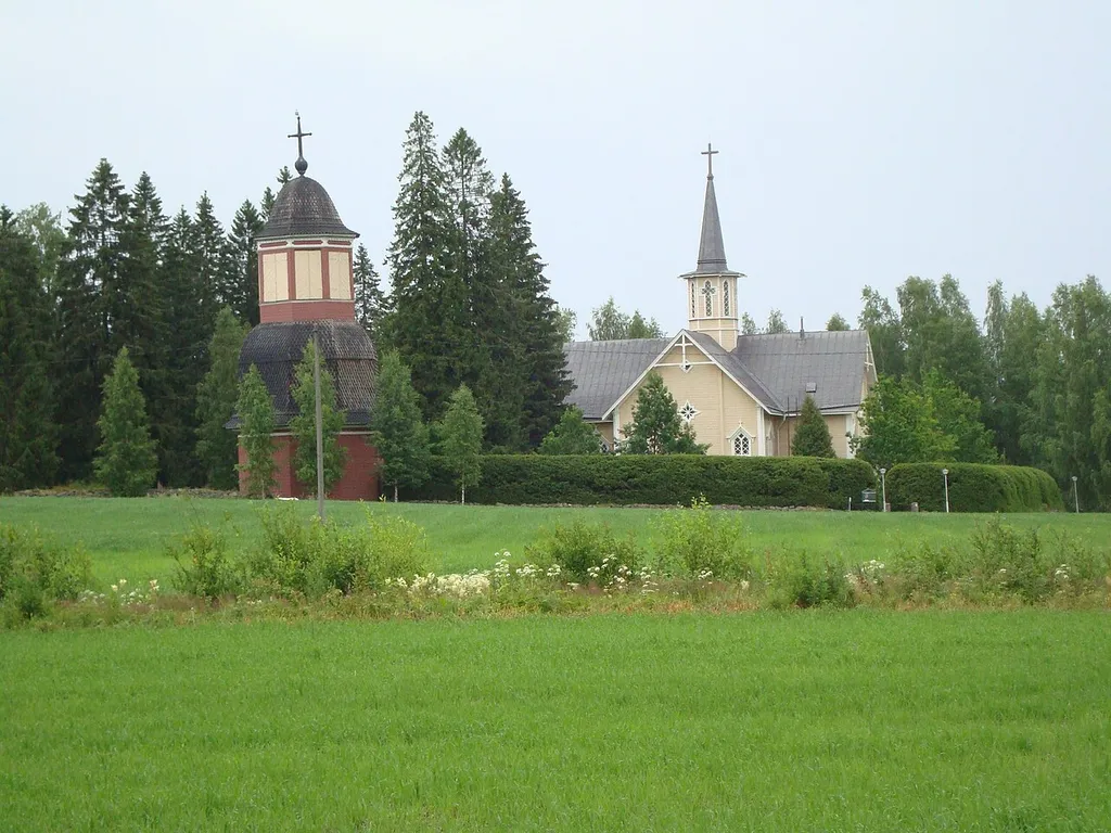 Suomenniemi church, built in 1866, and belfry, built in 1777, in Suomenniemi, South Karelia, Eastern Finland. The church is located about 750 metres from the village centre in an open field area. There is a small cemetery too.