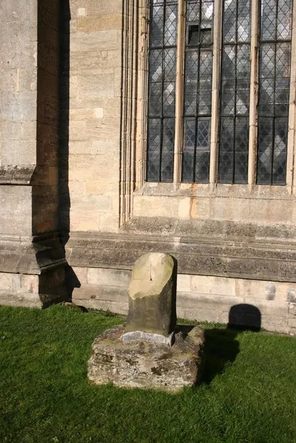 Base and broken shaft of 14th-century stone cross in the parish churchyard of SS Peter and Paul, Kirton, Lincolnshire