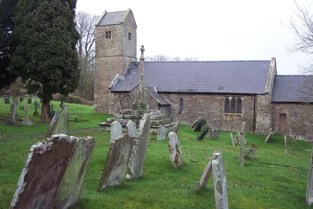 Wolvesnewton parish church with cross in the churchyard