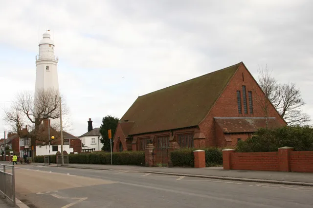 Withernsea Lighthouse and St Matthew's parish church, Owthorne, Withernsea, East Riding of Yorkshire, England.
