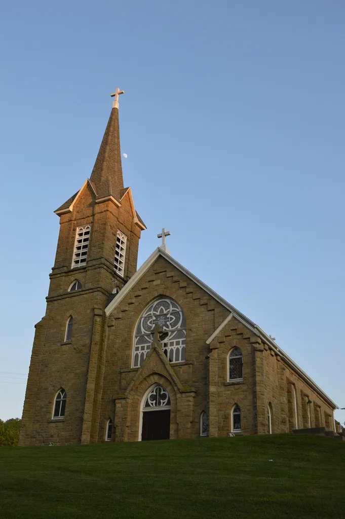 Front and western side of St. Henry's Catholic Church, located off Brumbaugh Road in Harriettsville, Ohio, United States. Built in 1894, it is listed on the National Register of Historic Places.