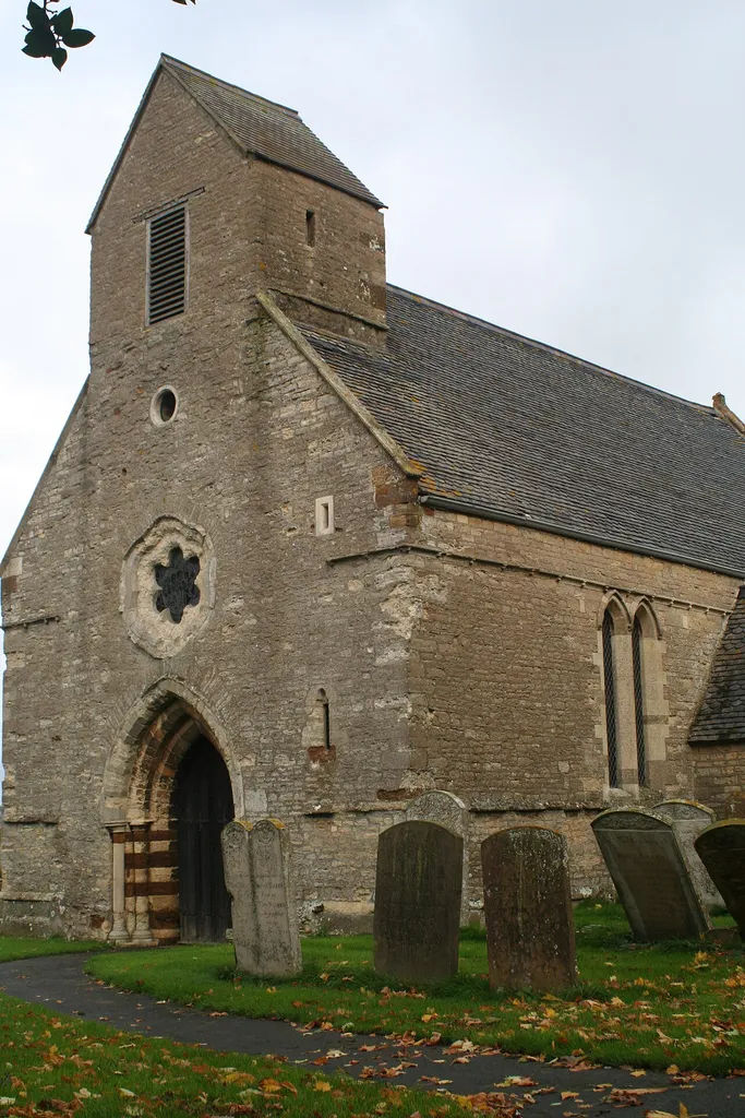 West front of St Romwald's parish church, Strixton, Northamptonshire, seen from the southwest. The west front is 13th-century. The rest of the church was rebuilt in 1873.