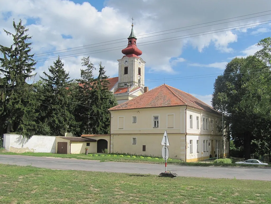 Dyjákovice in Znojmo District, Czech Republic. Center of the village with the church of St. Michael the Archangel and the municipal office.