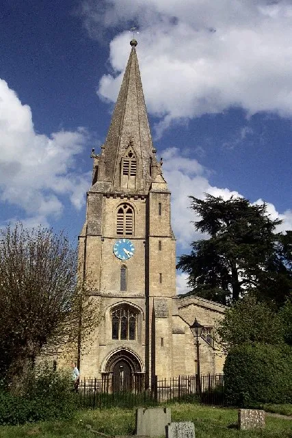 St Mary the Virgin parish church, Shipton-under-Wychwood, Oxfordshire: Early English 13th-century west tower and octagonal spire with lucarnes, and later Perpendicular Gothic window inserted over the west door