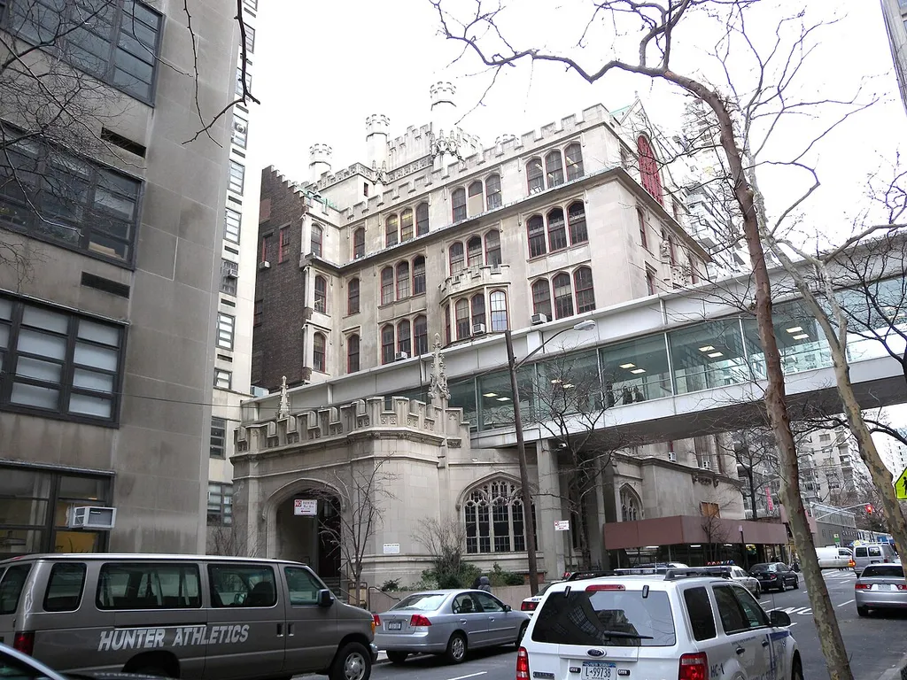 Looking east across East 68th Street at Hunter College skyway on a cloudy afternoon.