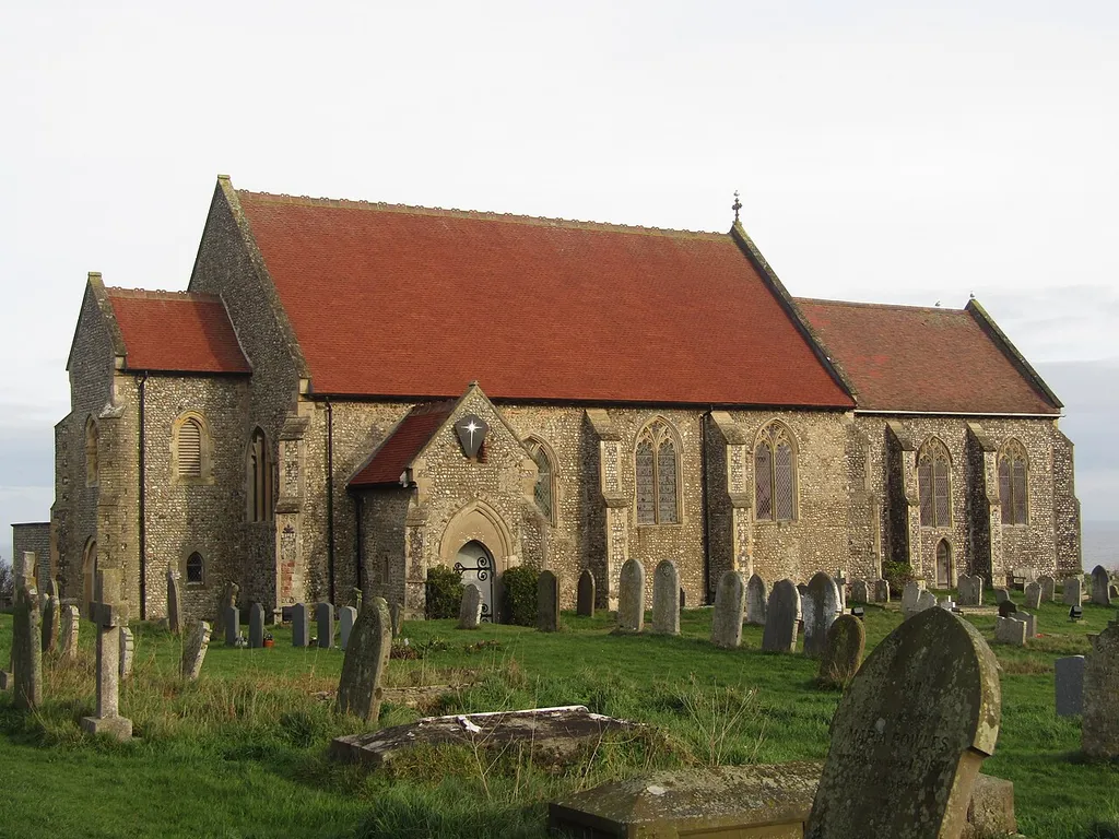 The south facing elevation of All Saints parish church in the village of Mundesley, Norfolk, United Kingdom.