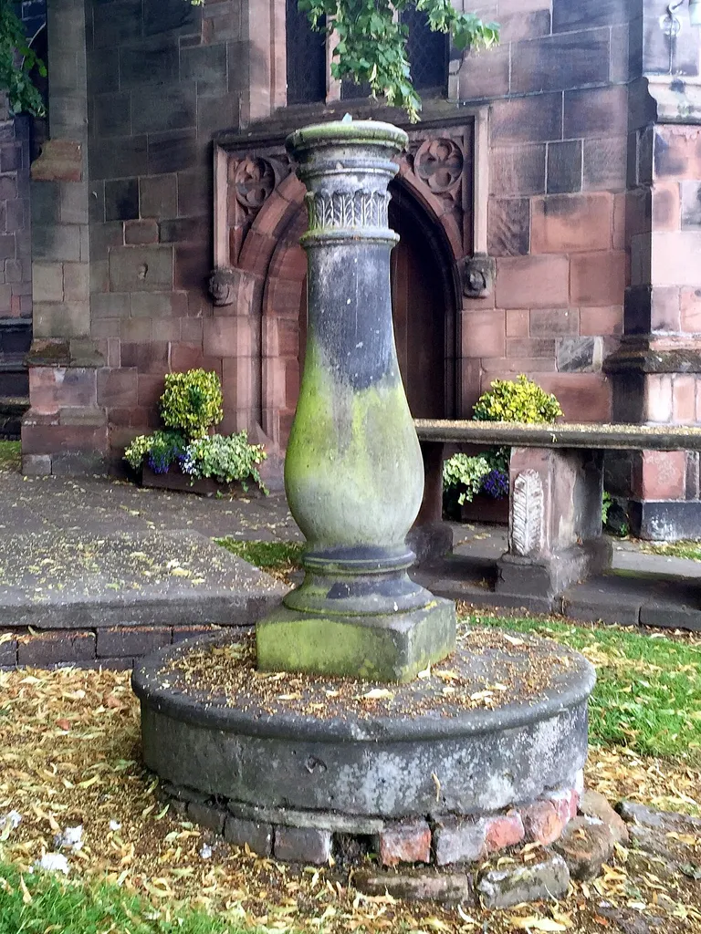 The sundial is in the churchyard of St Michael and All Angels Church. It is in stone and consists of a vase baluster on a circular stone step with a brick base. It has a copper dial, and the gnomon is broken.