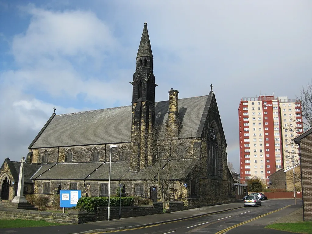 St Agnes' parish church, Stoney Rock Lane, Burmantofts, Leeds, seen from the east, with Shakespeare Towers on the right