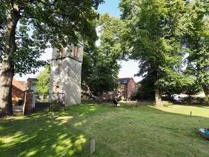 Standing tower and below ground remains of St Lawrence's Church and associated burial ground