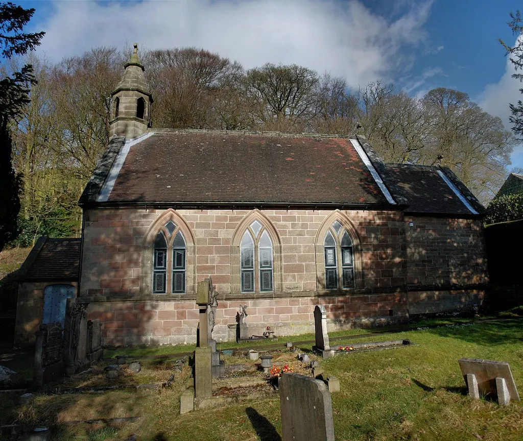This grade II listed 17th-century building, viewed here from the south, was a private chapel until 1870 when it became a parish church. The gritstone used for the walls almost certainly came from the nearby Stanton Moor Quarry. The three stained glass windows were fabricated for and donated to the church by artist Brian Clarke in 1977.
