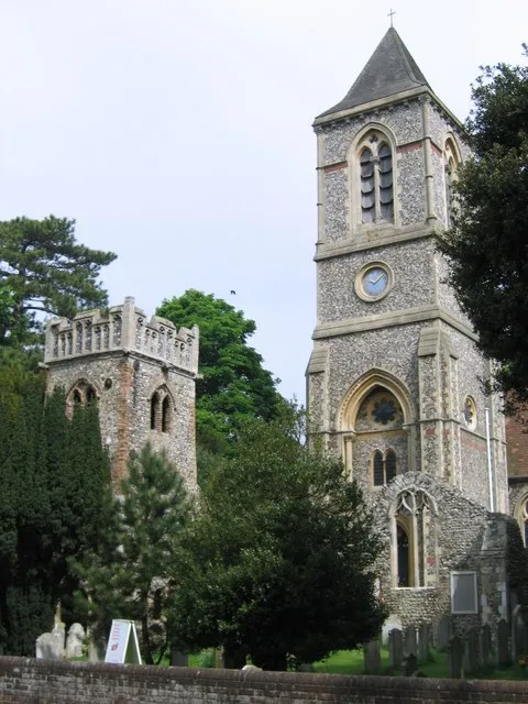 Church towers at Thorpe St Andrew, Norfolk. On the left is the 15th-century tower of the ruined former parish church. On the right is the Gothic revival tower added to the new parish church in 1882.