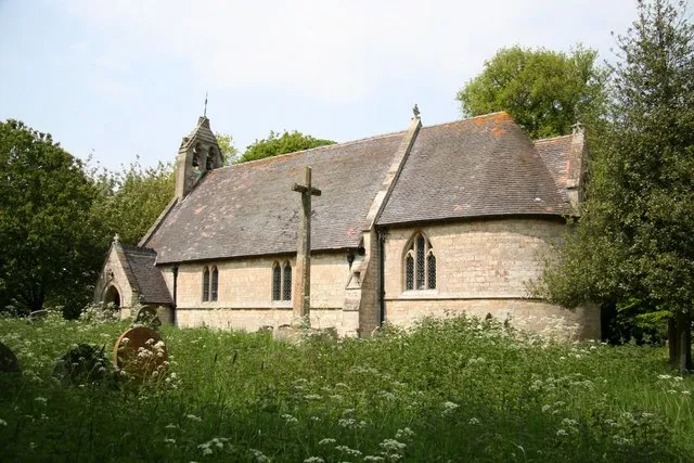 St Andrew's parish church, Firsby, Lincolnshire, seen from the southeast. The stone cross is the parish war memorial.