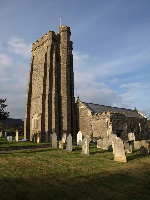 All Saints church, Thurlestone See also https://www.geograph.org.uk/gridref/SX6742?class=Church . Cherry &amp; Pevsner: "impressive C15 tower of unusual silhouette, since the stair-turret ... is markedly higher than the tower". At first I found the lack of openings above the first stage odd, but then realised that this is the side open to westerly gales.