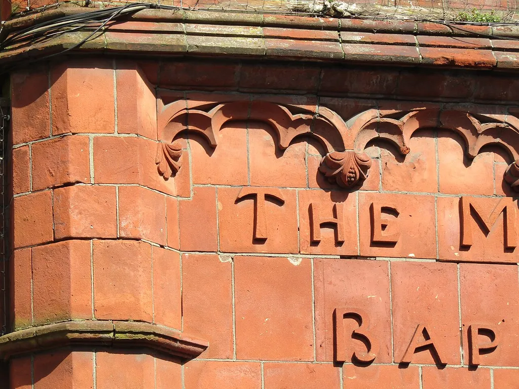 The front south facing facade of Cromer Baptist church with examples of carved letters by Cosseyware terracotta brickworks, located in Church street within the town of Cromer, Norfolk, England