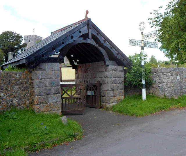 Lych gate and old Brecon County signpost, Penderyn The lych gate is at the Church Road entrance to Grade II listed St Cynog's Church. The lych gate was formerly used to shelter a coffin until the clergyman's arrival for the burial, or pre-burial service.Some sources state that the church is in Hirwaun, but the old signpost shows that Hirwaun is 2¼ miles away. The signpost is a survivor from the time of the administrative county of Brecon (or Brecknock), abolished in 1974 by the Local Government Act 1972. Most of the former county is now in Powys, but Penderyn is part of Rhondda Cynon Taf.