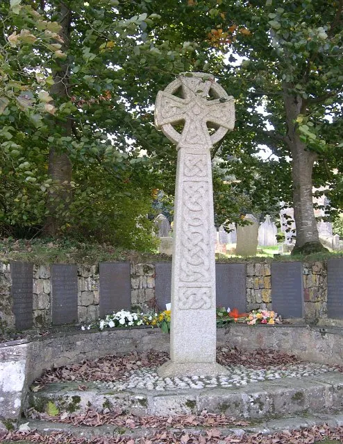 Perranzabuloe War Memorial. Such was the scale of the carnage in World War One that there was hardly a place in Great Britain left unaffected. In every town and large village there were built war memorials to commemorate the fallen of the area. Subsequently these had names added from the Second World War, although these were far fewer in number and occasionally you will see names of those who fell in more recent conflicts. Most of these memorials are rather bleak and hard looking but this is an exception. The names of the fallen are set in a semicircle in a low wall cut into the side of the churchyard with a large celtic cross at the centre. This memorial has a very peaceful feeling which the constant roar of traffic from the nearby main road cannot quite take away.