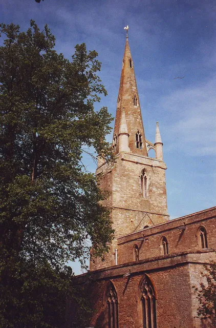 West tower and spire of the parish church of St Peter and All Saints, Harrold, Bedfordshire, seen from the southeast