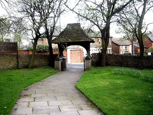 Lych gate and walls south, east and north of Church of St Andrew