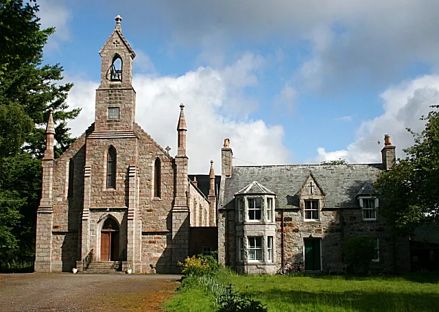 St Andrew's Roman Catholic Church The Church House is on the right, marked by a prominent cross on the gable of the central dormer window.