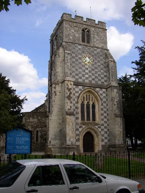 St Nicholas's Church, Barton in the Clay. The tower, in Perpendicular style, has an eye-catching chequered pattern of ashlar stone and cobbles.