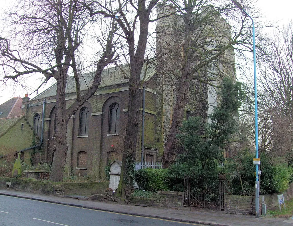 Former parish church of St Lawrence, High Street, Brentford, Middlesex, seen from the northwest. The west tower is 15th-century. The current nave was built in 1764. The church has been closed since 1979. Since this photo was taken, the war memorial outside the church (the stone with a gable in the centre) has been moved to Brentford Library.