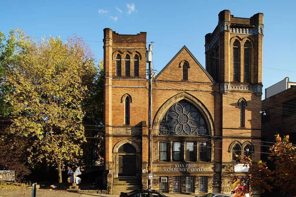 Photograph of First Presbyterian Church, Braddock, PA with sign for the Nyia Page Community Center