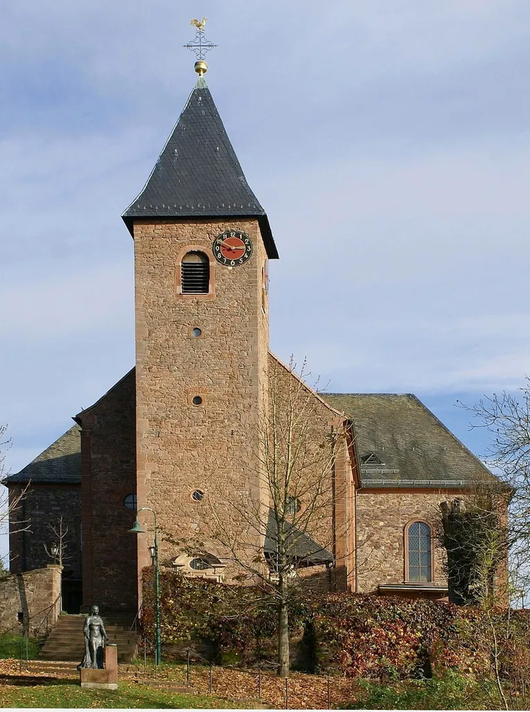 Die Pfarrkirche St. Maria Magdalena in Geiselbach. Links im Vordergrund ist die Statue der Maria Magdalena zu sehen.