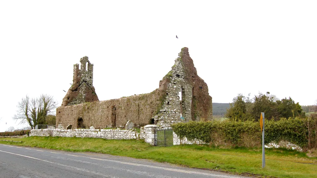 Clomantagh Church ruin from across the road (R693). A statue of the Virgin Mary has been placed in one of the windows.