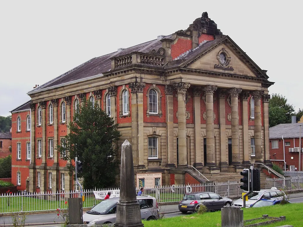 Zion Baptist Tabernacle of 1881 was built by George Morgan of Carmarthen. It is an impressive three storey building. The classical front in brick and freestone has a shaped gable above a Corinthian facade. In front is a portico and pediment. The interior is rich and a raked gallery on iron columns and a fine ironwork front. The basement was the schoolroom. Heated by hot air and lit by gas it was designed to accommodate 1,334 people. Today it survives with little alteration.