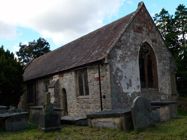 St Martin's Church, Preston Gubbals, near to Preston Gubbals, Shropshire, Great Britain. This building was originally the chancel of the mediaeval church; when a large new church was added to it in 1866, it became its south aisle; then the new church was demolished and the original building was vested in the Trust in 1975. A 17th century font and an outstanding 14th century effigial slab have survived all these vicissitudes. The remains of the demolished building can be seen alongside.