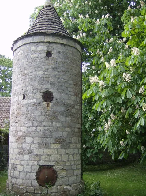 Water tower at Farleigh Hungerford "Small conical-roofed stone water tower", as it is described in the guidebook. Virtually opposite the church. Big font?