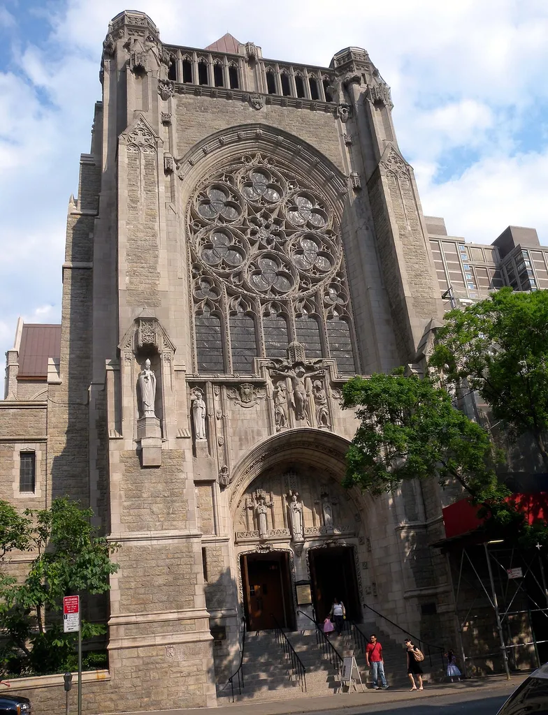 Looking southeast across Lexington Avenue and 66th Street at St Vincent Ferrer, renovations completed, on a sunny afternoon.