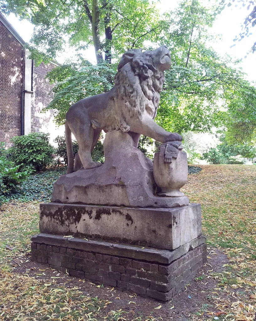 View of Thomas Cribb's tomb in St Mary's Gardens, the former churchyard of the 18th-century parish church of St Mary Magdalene, Woolwich, South East London. The wall is the backwall of the Odeon Cinema.
