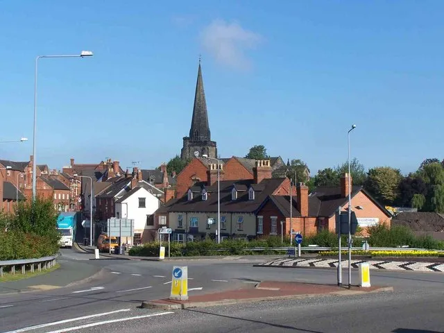 Bridge Street Uttoxeter, Staffordshire, England, with the tower and spire of St Mary the Virgin parish church in the background