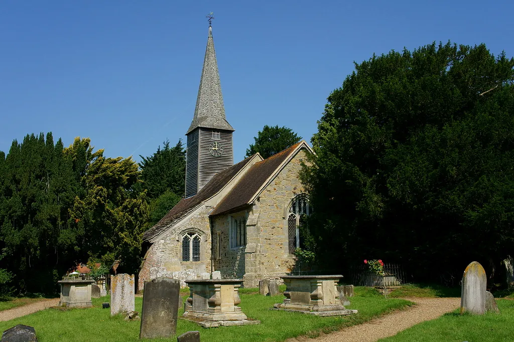 St George's parish church, Crowhurst, Surrey, seen from the southeast. To the right of the church is the Crowhurst Yew, an ancient tree thought to be up to 4000 years old. Despite the trunk being hollow, the tree seems to be in good health.