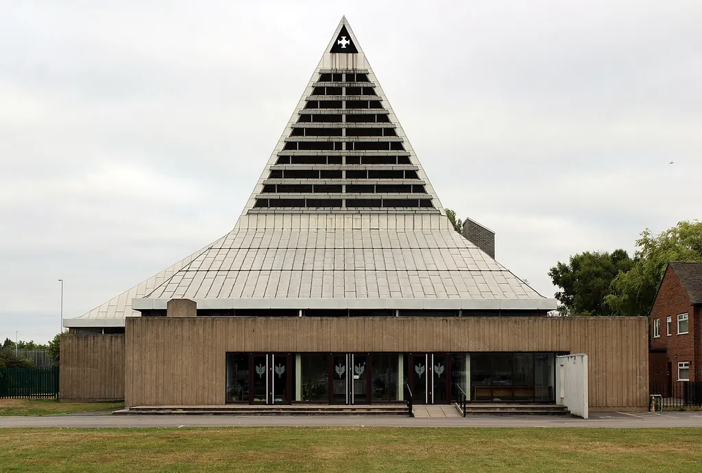 Grade II listed 1960s Roman Catholic church on the Woodchurch estate. Front elevation from New Hey Road.