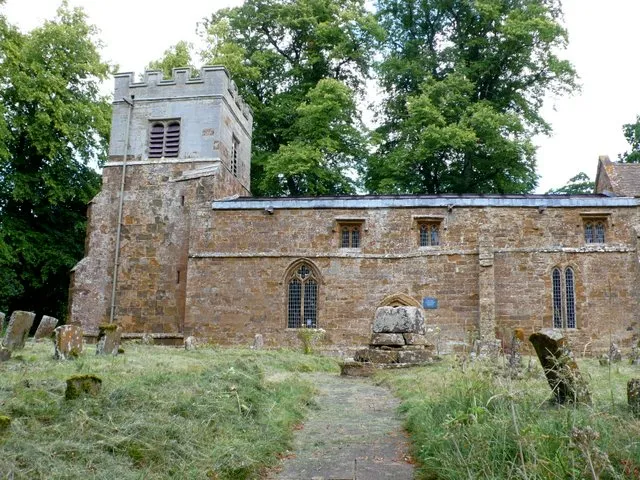 Nave and west tower of All Saints' parish church, Chadshunt, Warwickshire, seen from the south. Next to the path, obscuring the south door, is the base of a Medieval churchyard cross.
