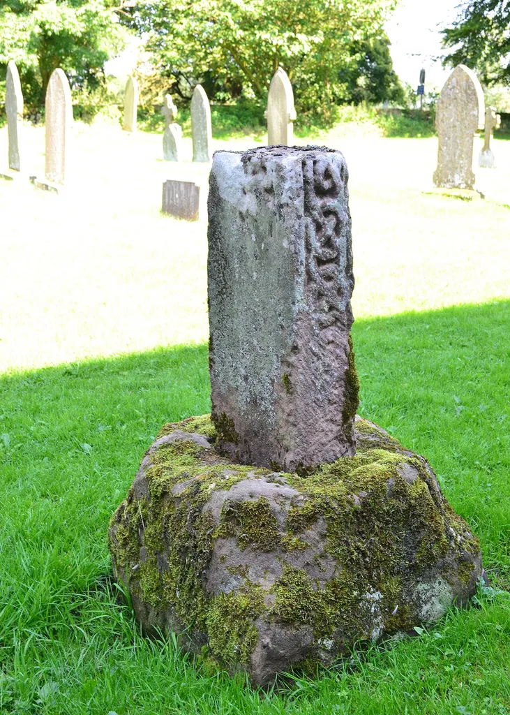 Photograph of the base of a cross shaft in the churchyard of St Peter's Church, Alstonefield, Staffordshire, England