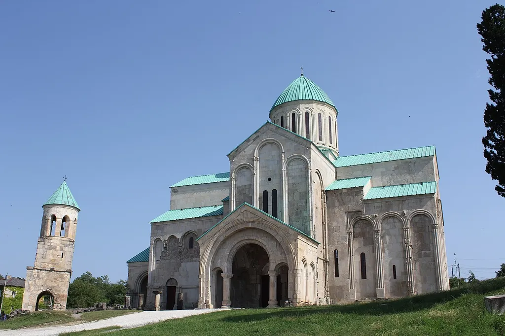 Kutaisi, Bagrati Cathedral The Cathedral of the Dormition, or the Kutaisi Cathedral, more commonly known as Bagrati Cathedral, is an 11th-century cathedral in the city of Kutaisi, in the Imereti region of Georgia. A masterpiece of the medieval Georgian architecture, the cathedral suffered heavy damage throughout centuries and was reconstructed to its present state through a gradual process starting in the 1950s, with major conservation works concluding in 2012. A distinct landmark in the scenery of central Kutaisi, the cathedral rests on the Ukimerioni Hill. Bagrati Cathedral was built in the early years of the 11th century, during the reign of King Bagrat III, thanks to which it was called "Bagrati", i.e. Bagrat’s cathedral. An inscription on the north wall reveals that the floor was laid in "chronicon 223", i.e. 1003. In 1692, it was devastated in an explosion by Ottoman troops who had invaded the Kingdom of Imereti. The incident caused the cupola and ceiling to collapse. Conservation and restoration works, as well as archaeological studies at the Cathedral began in the 1950s under the leadership of a Georgian architect Vakhtang Tsintsadze. The restoration works headed by Tsintsadze were divided into six stages and continued for several decades through 1994. That same year in 1994 Bagrati Cathedral, together with the Gelati Monastery, was included in UNESCO's World Heritage Site list as a single entity. In 2001, ownership of the cathedral was transferred from the Georgian state to the Georgian Orthodox Church. It is presently of limited use for religious services, but attracts many pilgrims and tourists. It is also frequently used as a symbol of the city of Kutaisi, being one of its main tourist attractions. In 2010, under the leadership of an Italian architect Andrea Bruno, Georgia commenced reconstruction works aimed at returning Bagrati Cathedral to its original state as a religious space. In July 2010, UNESCO added Bagratli cathedral to its list of endangered 