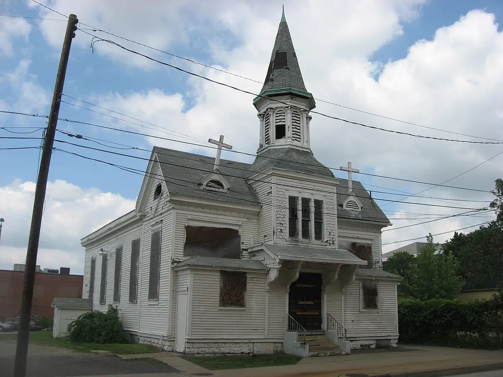 Front and eastern side of the former Welsh Congregational Church (now boarded up and abandoned, following a fire), located at 220 N. Elm Street in Youngstown, Ohio, United States. Built in 1861, it is listed on the National Register of Historic Places.