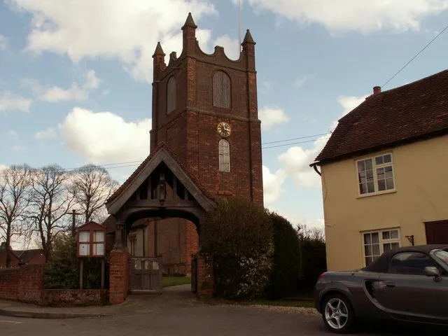 Lychgate and west tower of St Margaret of Antioch parish church, Toppesfield, Essex, seen from the west