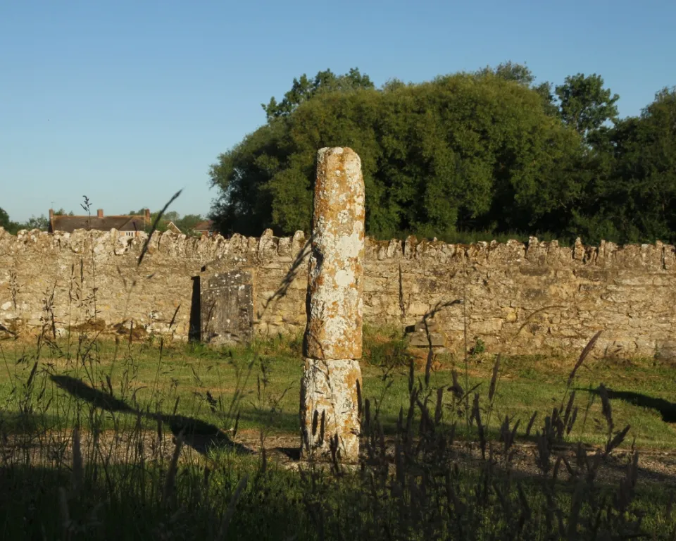 Base and broken shaft of medieval cross in All Saints' parish churchyard, Goosey, Oxfordshire (formerly Berkshire), seen from the east