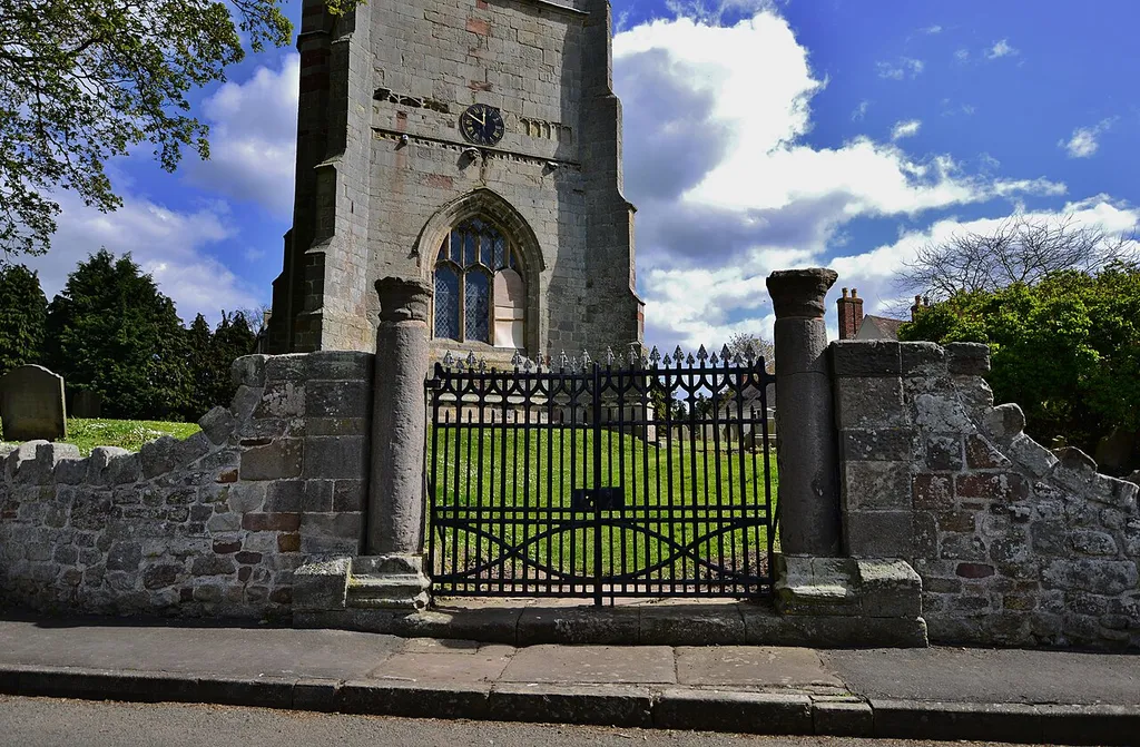 The churchyard entrance gate is flanked by two reused roman columns