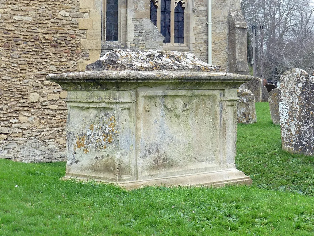 Grade II listed chest tomb in Bampton, Oxfordshire. Listed as "Chest tomb in churchyard of St Mary's circa 10 metres to south of south transept". .mw-parser-output .messagebox{margin:4px 0;width:auto;border-collapse:collapse;border:2px solid var(--border-color-progressive,#6485d1);background-color:var(--background-color-neutral-subtle,#fbfcff);color:var(--color-base,#202122);box-sizing:border-box;border-inline-start-width:8px}.mw-parser-output .messagebox.mbox-small{font-size:88%;line-height:1.25em}.mw-parser-output .mbox-warning,.mw-parser-output .mbox-speedy{border:2px solid var(--border-color-error,#b22222);background:var(--background-color-error-subtle,#ffdbdb);border-inline-start-width:8px}.mw-parser-output .mbox-serious,.mw-parser-output .mbox-delete,.mw-parser-output .mbox-stop{border:2px solid var(--border-color-error,#b22222);border-inline-start-width:8px}.mw-parser-output .mbox-issue,.mw-parser-output .mbox-content{border:2px solid #f28500;background:var(--background-color-warning-subtle,#ffe);border-inline-start-width:8px}.mw-parser-output .mbox-query,.mw-parser-output .mbox-style{border:2px solid #f4c430;background:var(--background-color-warning-subtle,#ffe);border-inline-start-width:8px}.mw-parser-output .mbox-shit{border:2px solid #960;border-inline-start-width:8px}.mw-parser-output .mbox-license{border:2px solid #88a;border-inline-start-width:initial}.mw-parser-output .mbox-legal{border:2px solid var(--border-color-notice,#666);background:var(--background-color-base,#fff);border-inline-start-width:8px}.mw-parser-output .mbox-honor{border:2px solid #ca3;background:var(--background-color-warning-subtle,#fcf4db);border-inline-start-width:8px}.mw-parser-output .mbox-growth{border:2px solid #8d4;background:var(--background-color-success-subtle,#d5fdf4);border-inline-start-width:8px}.mw-parser-output .mbox-move{border:2px solid #93c;border-inline-start-width:8px}.mw-parser-output .mbox-protection,.mw-parser-output .mbox-message{border:2px solid var(--border