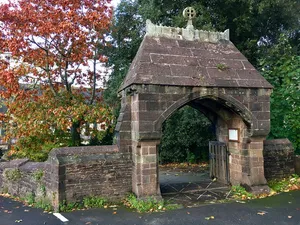 Lychgate and attached wall descending to the Cathedral